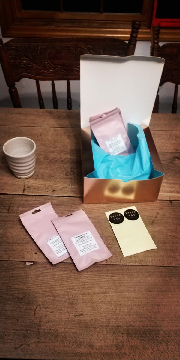 gift box with a white tumbler and tea packets inside