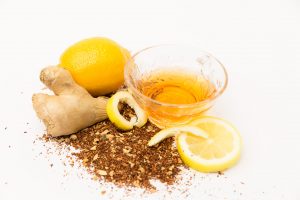 lemon ginger rooibos tea with lemons and a ginger root around it
